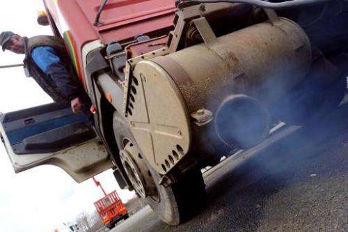 A mechanic starts up a 1989 truck with no particulate limiter on March 13, 2013 in Spay, western France