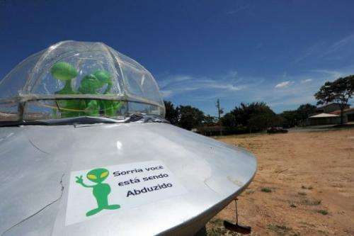 A mock UFO with a sign reading &quot;Smile, you are being abducted&quot; is pictured north of Brasilia, in December last year