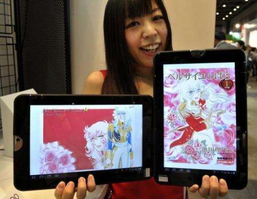 A model displays a tablet PC as an book reader, equipped with Google's Android OS, in Tokyo, on July 7, 2011