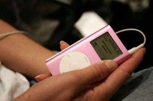 A model listens to music on her iPod backstage during Olympus Fashion Week  in New York on September 15, 2005