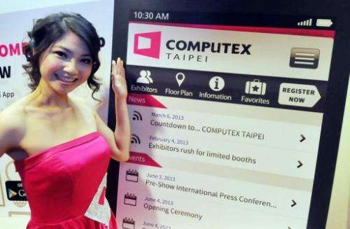 A model poses for photo during a pre-show press conference for the Computex fair in Taipei, on March 14, 2013