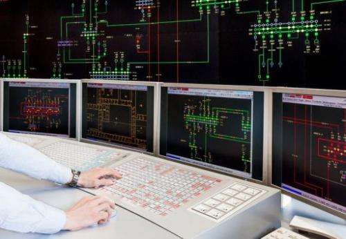 An Amprion employee watches a board displaying the electrical network at the power operator in Pulheim, on May 14, 2013