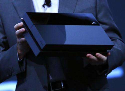 Andrew House, Sory President and CEO, holds up a Playstation 4 at the Sony Playstation E3 press conference June 10, 2013
