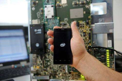 An emplyee holds a smatphone, at the Intel smartphones' research center in Toulouse, on March 2, 2012