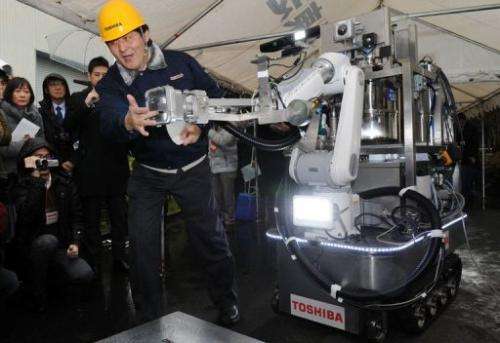 An engineer of Toshiba displays a decontamination robot in Yokohama, suburban Tokyo on February 15, 2013