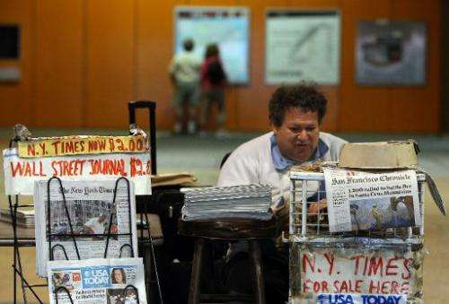 A newspaper vendor waits for customers at his stand in an underground rail station October 26, 2009 in San Francisco, California