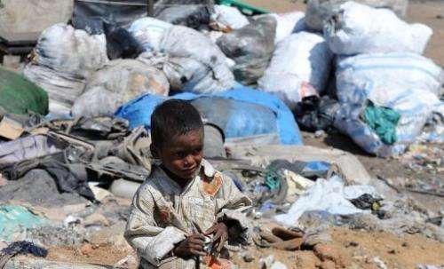 An Indian child plays in a slum on the outskirts of Hyderabad on June 5, 2012
