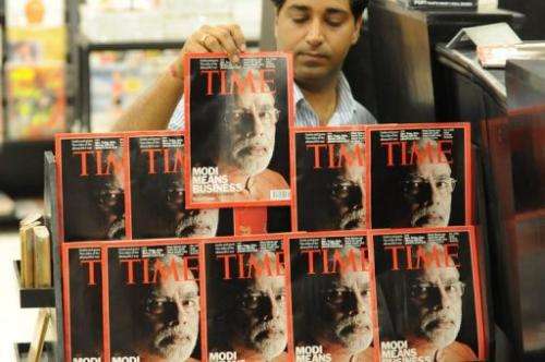 An Indian salesman arranges copies of Time magazine in Ahmedabad on March 18, 2012