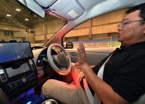 A passenger sits in Nissan's new self-driving car at the CEATEC preview in Chiba on September 30, 2013