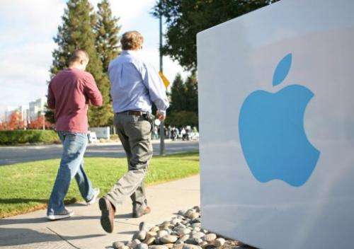 Apple employees walk towards the Apple Headquarters in Cupertino, California, on October 19, 2011