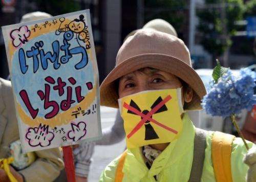 A protester holds a placard at an anti-nuclear rally in Tokyo on June 2, 2013