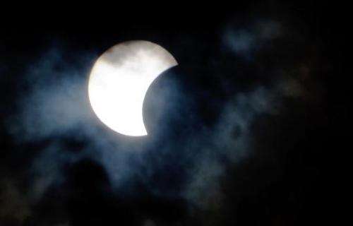 A rare hybrid solar eclipse is seen through clouds from the Canary Island of Tenerife on November 3, 2013