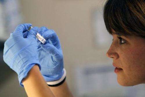 A researcher manipulates a sample at Vall d'Hebron Research Institute in Barcelona on June 20, 2013