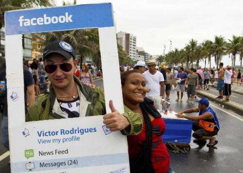 A reveller fancy dressed as a Facebook profile joins the Banda de Ipanama carnival street band as they parade along Ipanema beac
