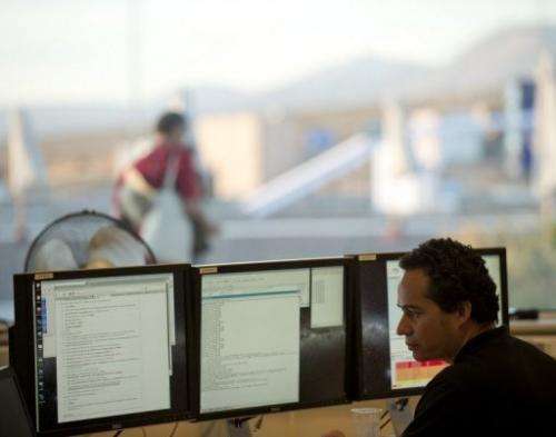 A scientist works at a control station of the ALMA project, in northern Chile's Atacama desert, on March 12, 2013