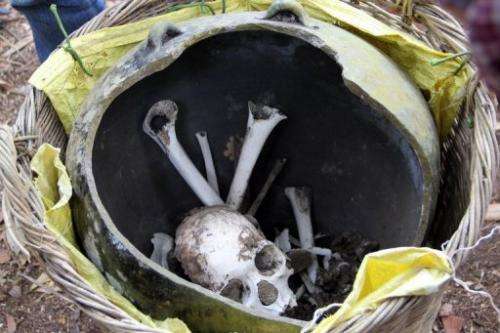 A skull and bones in broken jars in a remote Cambodian jungle, on January 7, 2013