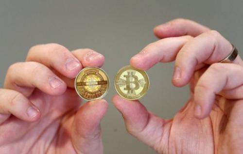 A software engineer shows shows physical bitcoin, minted in Sandy, Utah, on April 26, 2013