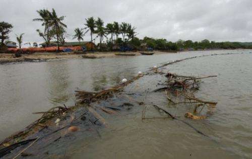 A stretch of oil spill boom made of improvised materials is seen on central Guimaras island, on September 4, 2006
