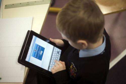 A student uses an iPad digital tablet at school on December 3, 2012 in Croissy-sur-Seine, east of Paris