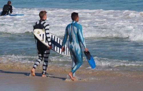 A surfer and diver wear Shark Attack Mitigation Systems (SAMS) wetsuits on July 18, 2013