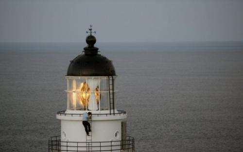 A Taiwanese government employee inspects a lighthouse at Santiaochiao, on July 11, 2013