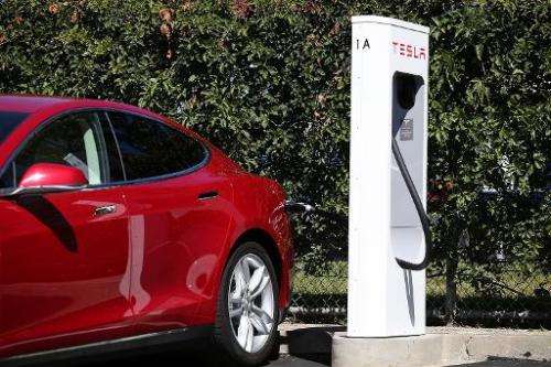 A Tesla model S sedan is plugged into a Supercharger outside the company's factory in Fremont, California on August 16, 2013