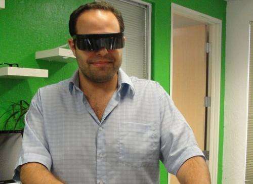 Atheer co-founder Soulaiman Itani poses with the prototype glasses that overlay the Internet on the real world in 3D