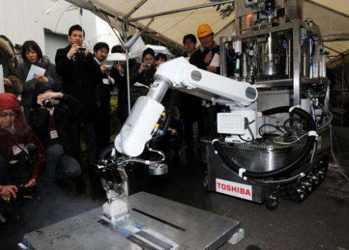 A Toshiba decontamination robot is demonstrated at Toshiba's technical center in Yokohama on February 15, 2013