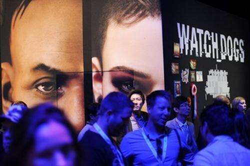 Attendees stand at the &quot;Watch Dogs&quot; display at the E3 gaming industry conference in Los Angeles June 12, 2013