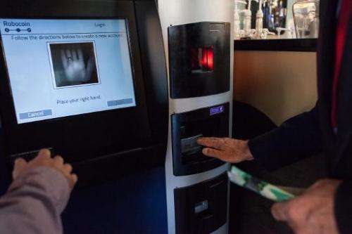 A user tries out the world's first bitcoin ATM at Waves Coffee House on October 29, 2013 in Vancouver, British Columbia