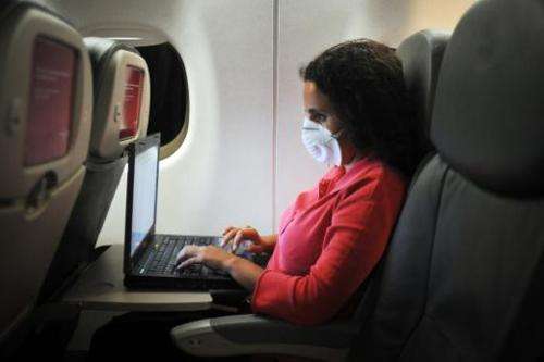 A uses a laptop during a flight from Guatemala to Mexico on April 28, 2009