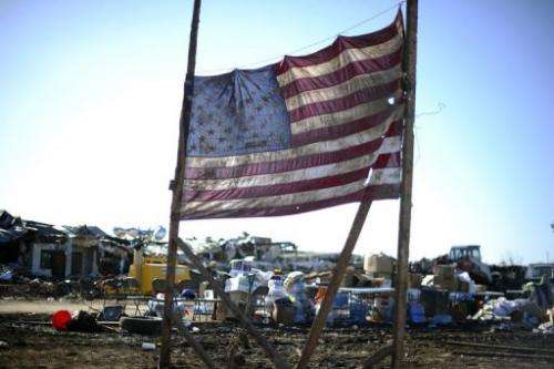A US flag is displayed amongst the debris of the tornado devastated school on May 22, 2013 in Moore, Oklahoma