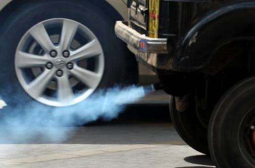 A vehicle emits exhaust fumes on a road in Bangalore on December 3, 2009