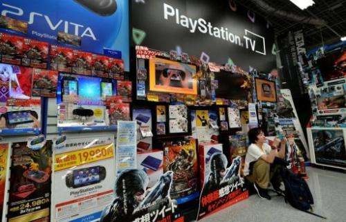 A videogame fan plays Sony's portable videogame console at a shop in Tokyo, Japan on February 20, 2013