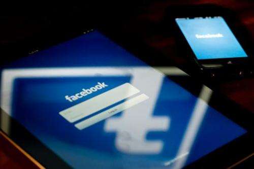 A view of a tablet and a smartphone displaying the Facebook app's splash screen on May 10, 2012 in Washington, DC