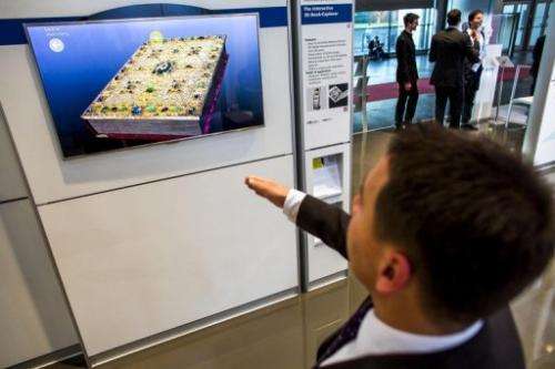 A visitor tests an interactive 3-D boook explorer at the 2013 CeBIT technology trade fair in Hanover, on March 5, 2013