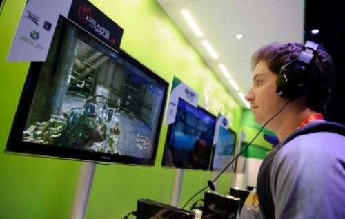 A visitor tries out the Microsoft Xbox 360 at the 2012 International Consumer Electronics Show in Las Vegas