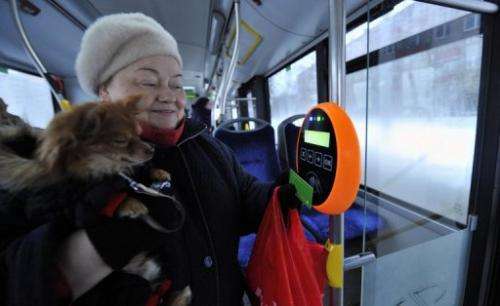 A woman and her dog make the most of free travel on a bus in Tallinn, on January 9, 2013