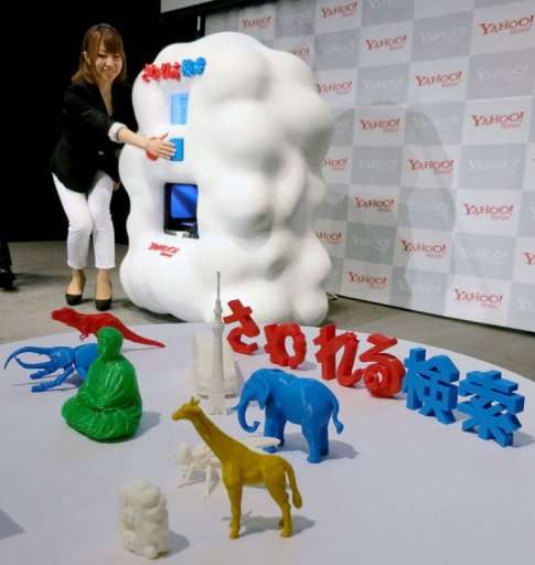 A woman demonstrates a voice-activated Internet search engine linked to a 3D printer in Tokyo on September 17, 2013