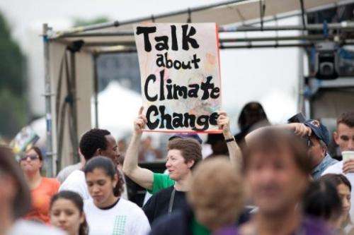 A woman holds a sign advocating more attention for climate change at a rally on April 25, 2010 in Washington, DC
