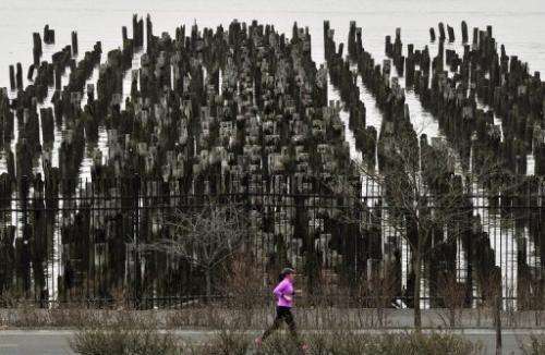A woman jogs past an old pier along the Hudson River in New York on January 10, 2013