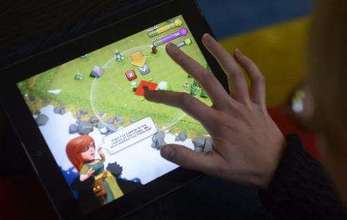 -A woman plays the Clash of Clans game of Finnish computer game maker Supercell on a tablet computer on December 14, 2012 in Hel