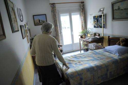 A woman walks in her room on March 18, 2011 in Angervilliers, eastern France.