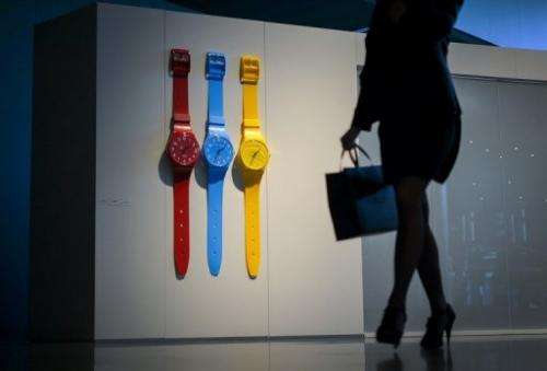 A woman walks through the booth of Swiss watchmaker Swatch on the opening day of watch fair Baselworld on April 25, 2013