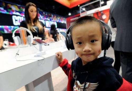 A young boy listens to music on a pair of headphones at the CES in Las Vegas on January 9, 2013