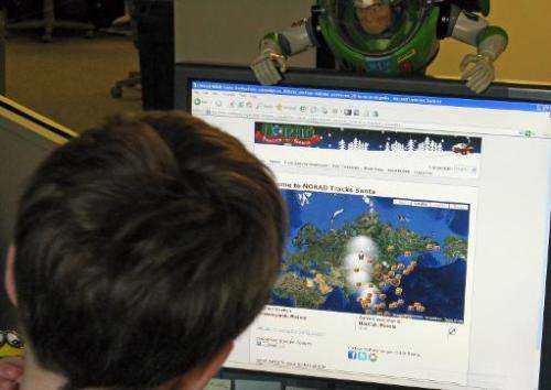 A young boy looks at the website (www.noradsanta.org) to check on the progress of Santa Claus on December 24, 2009 in Washington
