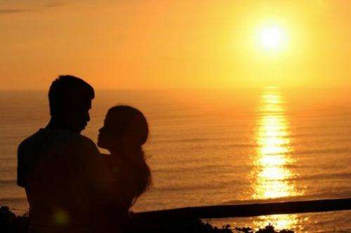 A young couple cuddle while watching the sunset in the &quot;Park of Love&quot; in Lima, Peru on February 14, 2006