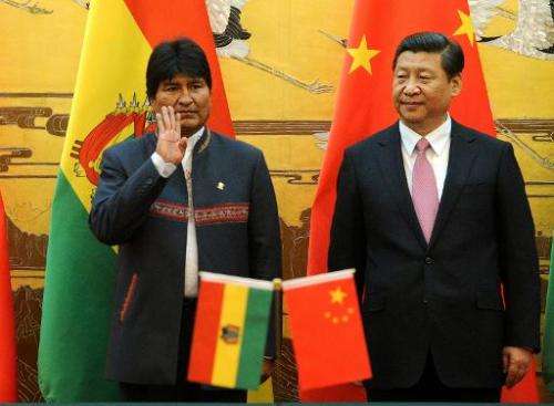 Bolivian President Evo Morales (L) reacts as he attends a signing ceremony with Chinese President Xi Jinping at the Great Hall o