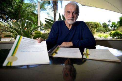 Brazilian inventor Nelio Jose Nicolai displays the patent register after an interview in Brasilia, on February 14, 2013