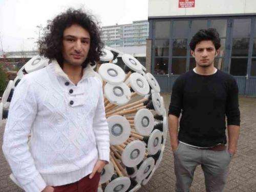 Brothers Massoud (L) and Mahmud Hassani show off their "mine kafon" at their Eindhoven workshop on December 19, 2012
